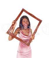 Smiling woman looking trough picture frame