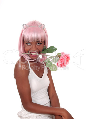 Woman holding a pink rose in her mouth