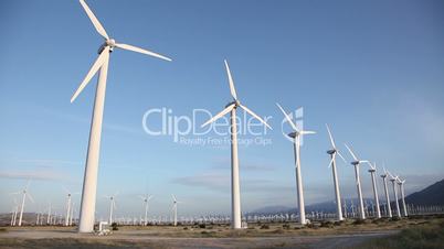 Large Group of Wind Turbines Spinning In The Desert.