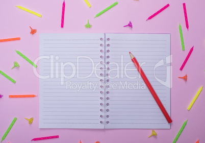 notebook in line and red wooden pencil