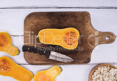 fresh pumpkin on a brown wooden board