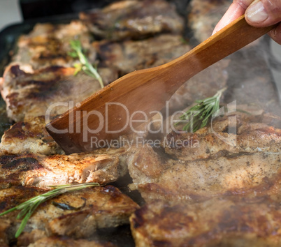 Pork steaks are roasted on a grill