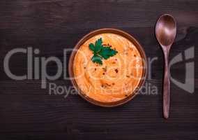 pumpkin soup in a round clay plate