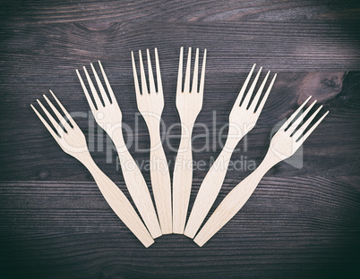 carved wooden forks on a brown background