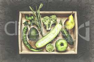 A set of green vegetables and fruits in a wooden box
