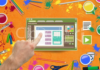 Hand touching Web design editor window and creative art objects on Paper cut out desktop