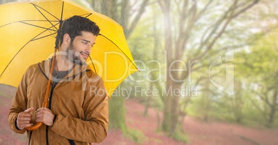 Man in Autumn with umbrella in bright forest