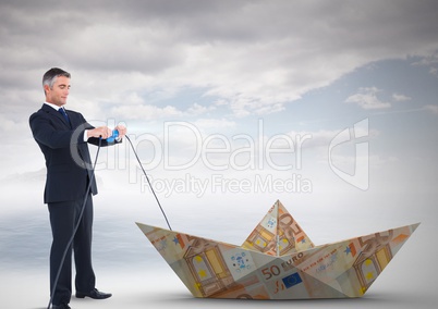 Businessman with paper money euro boat and electricity socket lead