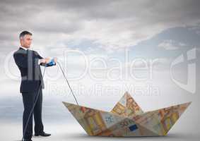 Businessman with paper money euro boat and electricity socket lead
