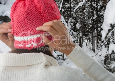 Woman wearing hat in snow forest