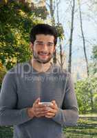 Man in Autumn with cup in forest
