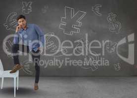 man leaning on chair in front of money on wall