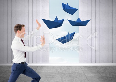 Businessman with floating energy of paper boats