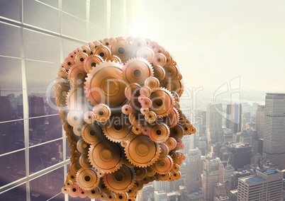 3d head made of cogs cityscape with skyscrapers