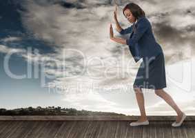 Businesswoman pushing the air with sky
