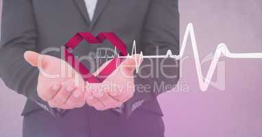 Heart beat over businessman hands holding heart