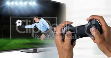 Hands with game controller in front of tv screen with goalkeeper reaching out the ball