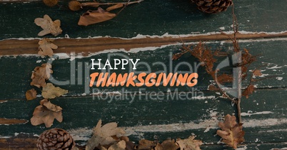 Happy thanksgiving text with wood and Autumn leaves
