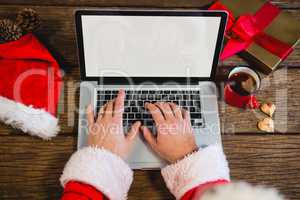 Santa Claus using laptop