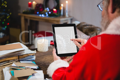 Santa Claus using digital tablet