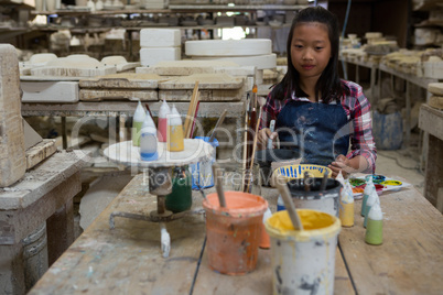 Portrait of girl painting bowl