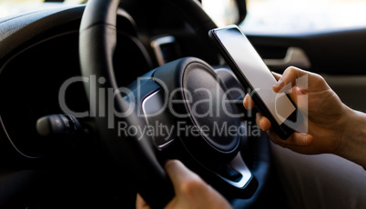 Close-up of man using smartphone while test driving in car