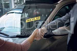 Cropped image of salesman doing handshake with customer