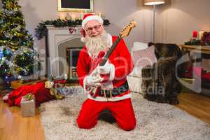 Smiling santa claus playing a guitar