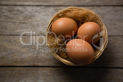 Three eggs on wicker bowl