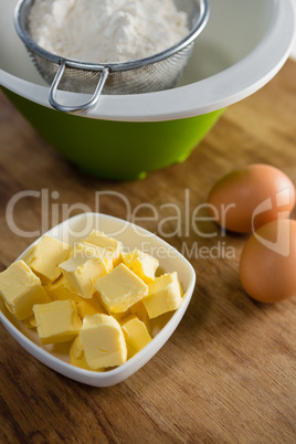 Flour in strainer with eggs and cheese