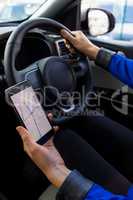 Close up of female customer using phone during test drive