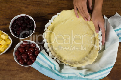 Woman preparing fruit tart