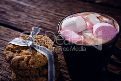 Cookies and hot chocolate on wooden plank