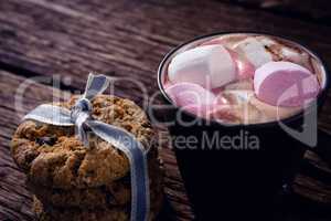 Cookies and hot chocolate on wooden plank