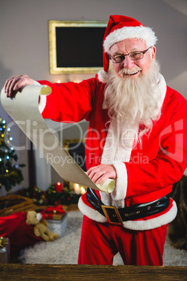 Santa Claus holding scroll in living room