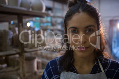 Female potter smiling in pottery workshop