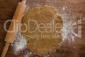 Flattened dough on a wooden table