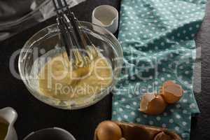 Freshly whisked batter of beaten eggs, milk and butter in a bowl