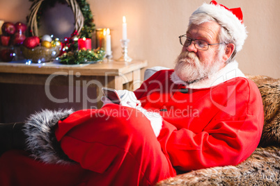 Santa claus sitting and using mobile phone