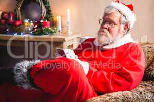 Santa claus sitting and using mobile phone