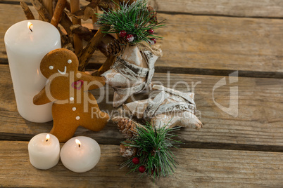 High angle view gingerbread cookie with star shape decorating and illuminated candles