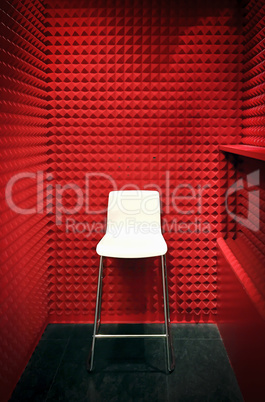 white stool in a red soundproof cabin