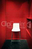 white stool in a red soundproof cabin