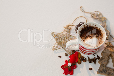 Coffee with cinnamon powder and christmas decorations