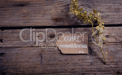 Thanksgiving card and flora on wooden plank
