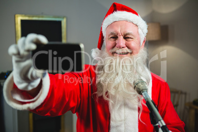 Santa claus taking selfie from mobile phone