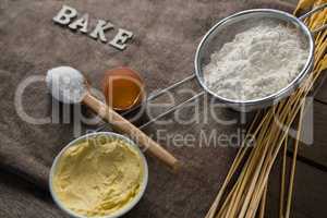 Flour inside sieve placed over wheat stem