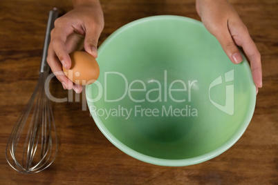 Woman holding a brown egg