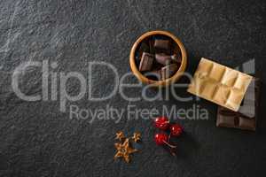 Chocolates and fruit on concrete background