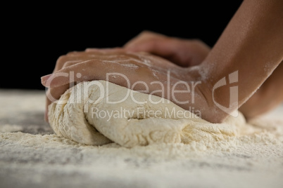 Woman kneading a dough